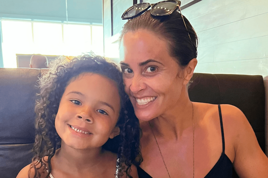Mother and daughter smiling together, highlighting the importance of positive body image and self-worth.