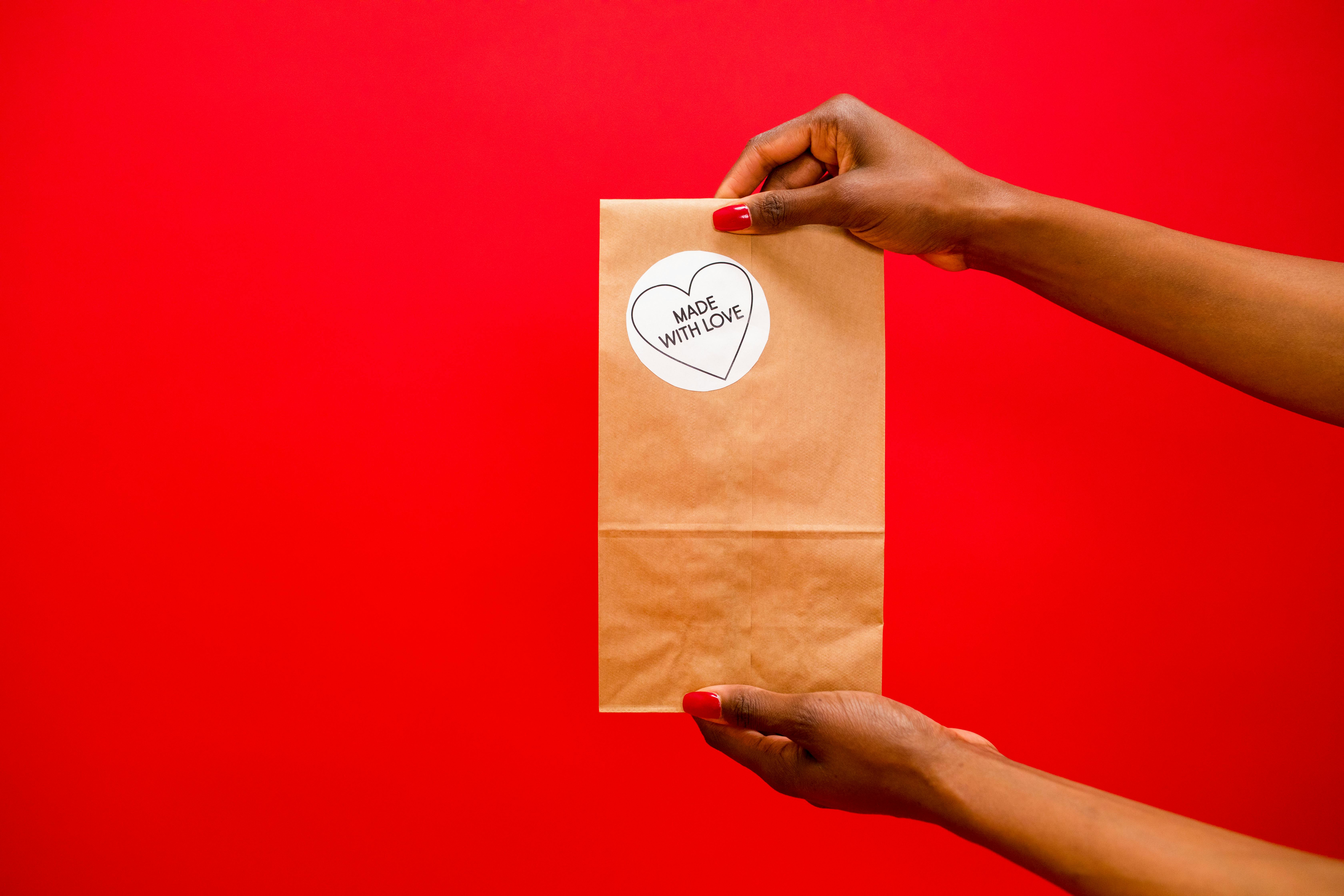 A hand holding out a gift of friendship.