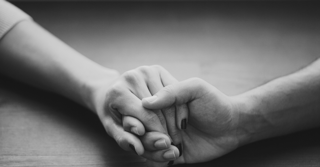 A mom and daughter holding hands.