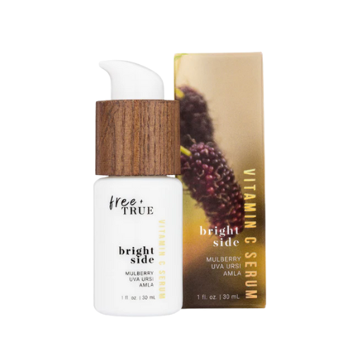 A bottle of Free + True Skincare’s Bright Side Vitamin C Serum displayed on a clean, minimalist surface, with soft natural lighting highlighting the product’s bright, nourishing design.