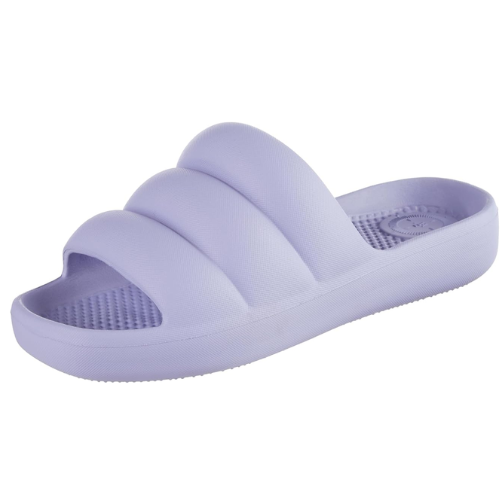 A pair of Totes Puffy Platform Slides in a soft neutral shade, shown at an angle to display their cushioned Everywear™ technology and lightweight, waterproof design.