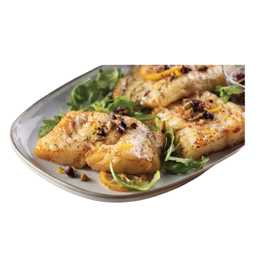 A plate of grilled fish fillets from Omaha Steaks garnished with herbs and citrus slices, served on a bed of arugula.