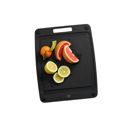 A black cutting board with sliced citrus fruits including grapefruit, lemon, and lime, along with a whole tangerine and a sprig of green leaves.