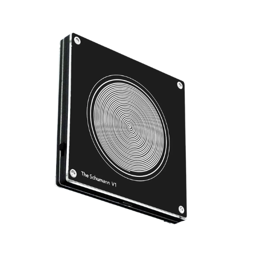 A black square device featuring concentric spiral lines, labeled 'The Schumann V1' at the bottom.
