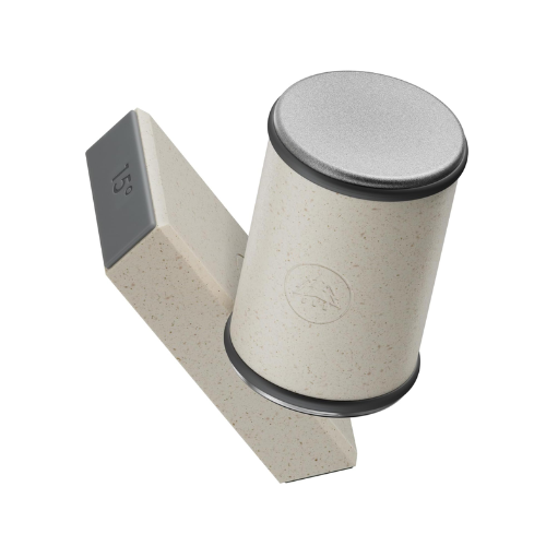 A stylish cylindrical container with a silver lid, placed beside a light-colored angular block. The container features a textured finish and is tilted at an angle for a modern appearance.